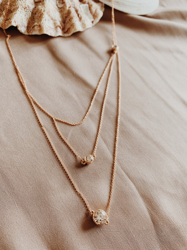 Rose gold tri-strand necklace with three Swarovski crystals.