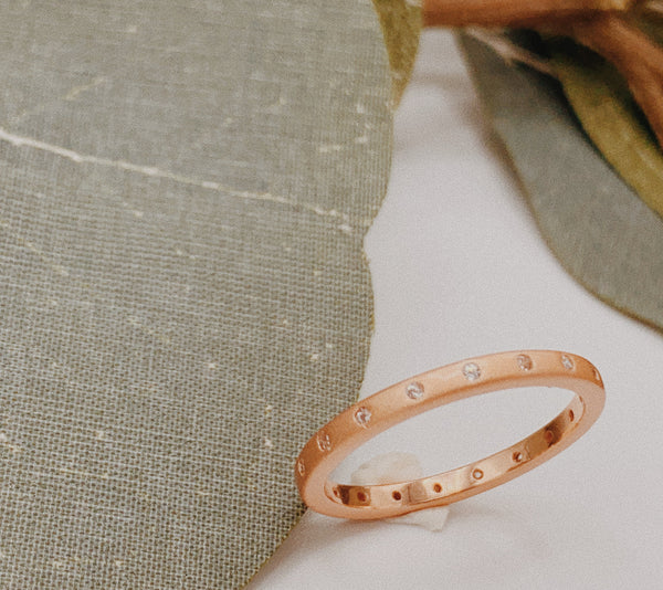 Matte rose gold ring with 18-eternity stones.