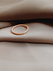 Matte rose gold ring with 18-eternity stones.