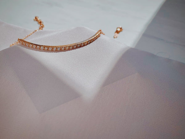 Rose gold diamond bar bracelet with 24 diamonds.