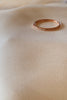 Rose gold ring with seven diamonds.